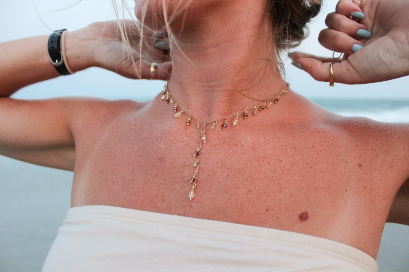 A beaded drop necklace worn at the shore